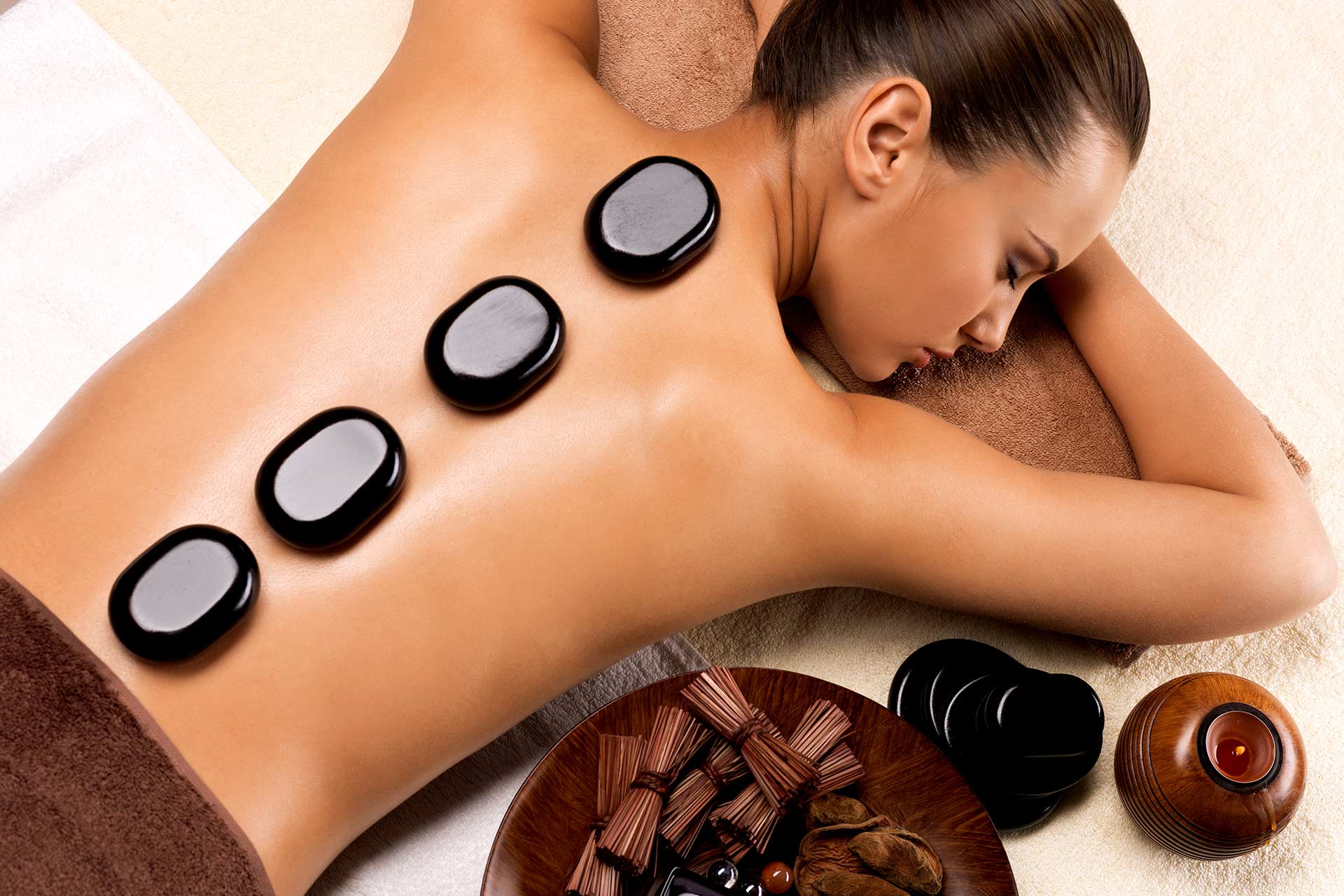 beautiful-woman-relaxing-in-spa-salon-with-hot-stone